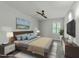Comfortable bedroom featuring a ceiling fan, a mounted TV and beach-themed art at 1234 Shadowbark Ct, Raleigh, NC 27603