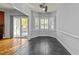 Dining room featuring hardwood floors, modern windows, and a glass door to the deck at 1234 Shadowbark Ct, Raleigh, NC 27603