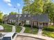 Residential street view showing a row of brick townhomes with well-kept lawns and mature trees at 1234 Shadowbark Ct, Raleigh, NC 27603