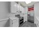 Bright kitchen featuring white cabinets and stainless steel appliances at 1234 Shadowbark Ct, Raleigh, NC 27603