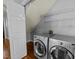 Laundry room featuring modern washer and dryer units with overhead shelving at 1234 Shadowbark Ct, Raleigh, NC 27603
