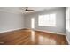 Open bedroom with hardwood floors and a ceiling fan at 126 W Savannah Ridge Rd, Holly Springs, NC 27540