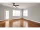 Bright bedroom featuring hardwood floors, two windows and white trim at 126 W Savannah Ridge Rd, Holly Springs, NC 27540