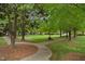 Inviting green space with benches and walking paths provides a serene community atmosphere at 126 W Savannah Ridge Rd, Holly Springs, NC 27540