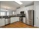 Bright kitchen boasting stainless steel appliances, ample counter space, and hardwood floors at 126 W Savannah Ridge Rd, Holly Springs, NC 27540