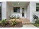 Charming back porch with seating and a view of the landscaped yard at 1306 Mordecai Dr, Raleigh, NC 27604