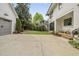 Spacious backyard with mature trees, a patio, and a detached garage at 1306 Mordecai Dr, Raleigh, NC 27604