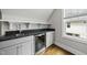 Close up on a bar area with gray cabinets, a beverage fridge, granite countertops, and open shelving at 1306 Mordecai Dr, Raleigh, NC 27604