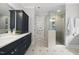 Modern bathroom with a glass-enclosed shower, tile flooring, and vanity with cabinets at 1306 Mordecai Dr, Raleigh, NC 27604