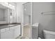 Bright bathroom featuring a granite countertop, a well-lit mirror, and a partial view into another room at 1306 Mordecai Dr, Raleigh, NC 27604