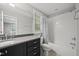 Clean bathroom features a dark vanity with drawers, a large mirror, and a shower/tub combo at 1306 Mordecai Dr, Raleigh, NC 27604