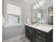 Bathroom with a window for natural light, a stylish mirror and sleek fixtures at 1306 Mordecai Dr, Raleigh, NC 27604