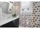Charming powder room features vibrant floral wallpaper, a round mirror, and a sleek vanity at 1306 Mordecai Dr, Raleigh, NC 27604