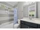 Bathroom with a tub and shower combination, toilet, and vanity with dark cabinets at 1306 Mordecai Dr, Raleigh, NC 27604