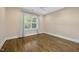 Bedroom with ceiling fan, light walls, hardwood floors, white trim, and plantation shutters at 1306 Mordecai Dr, Raleigh, NC 27604