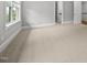 Spacious bedroom featuring neutral carpet, white trim, and large windows with natural light at 1306 Mordecai Dr, Raleigh, NC 27604