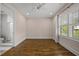 Bright bedroom with hardwood floors, a ceiling fan, and a window for natural light at 1306 Mordecai Dr, Raleigh, NC 27604