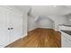 Cozy, bonus room featuring hardwood floors, recessed lights, storage closet, and a sloped ceiling at 1306 Mordecai Dr, Raleigh, NC 27604