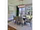 Dining room with table, chairs, chandelier, area rug, and sliding doors to the backyard at 1306 Mordecai Dr, Raleigh, NC 27604