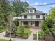 Beautiful two-story home with landscaped front yard and a black metal fence at 1306 Mordecai Dr, Raleigh, NC 27604