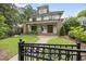 Charming two-story home featuring a brick-accented porch, manicured lawn, and inviting curb appeal at 1306 Mordecai Dr, Raleigh, NC 27604