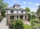 Inviting two-story home with well-manicured front yard, pathway, and a quaint front porch at 1306 Mordecai Dr, Raleigh, NC 27604