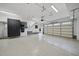 Well-organized garage featuring epoxy floors, custom cabinets, and utility sink with storage at 1306 Mordecai Dr, Raleigh, NC 27604
