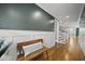 Elegant hallway with bench seating, wainscoting, and hardwood floors leading to stairs at 1306 Mordecai Dr, Raleigh, NC 27604