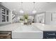Bright kitchen with white countertops, a farmhouse sink, and views to the living space at 1306 Mordecai Dr, Raleigh, NC 27604