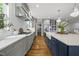 Open concept kitchen with modern appliances, a spacious layout, and hardwood flooring at 1306 Mordecai Dr, Raleigh, NC 27604