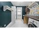 Convenient laundry room with washer/dryer, ample counter space, and stylish wallpaper at 1306 Mordecai Dr, Raleigh, NC 27604