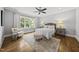 Bedroom featuring neutral walls, ceiling fan, hardwood floors, and lots of natural light at 1306 Mordecai Dr, Raleigh, NC 27604