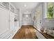 Well-organized mud room with hardwood floors, custom storage cabinets and drawers, and a bench at 1306 Mordecai Dr, Raleigh, NC 27604