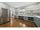Light-filled pantry area featuring custom cabinets, shelving, and a stainless steel refrigerator at 1306 Mordecai Dr, Raleigh, NC 27604