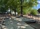 Park area with tables, benches, and playground in the background, ideal for outdoor gatherings at 1306 Mordecai Dr, Raleigh, NC 27604
