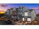 Charming multi-colored townhomes, with well-maintained landscaping and inviting entrances, at dusk at 133 Pearl St # 7, Garner, NC 27529