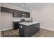 Modern kitchen features black cabinets, stainless steel appliances, and a convenient island at 133 Pearl St # 7, Garner, NC 27529