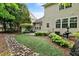 Backyard with patio and landscaping including a dry creek bed at 13338 Ashford Park Dr, Raleigh, NC 27613