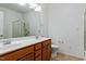 Bright bathroom with a double sink vanity, large mirror, and a glass shower at 13338 Ashford Park Dr, Raleigh, NC 27613