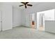 Spacious bedroom with multiple doors and hallway views, freshly painted in neutral colors at 13338 Ashford Park Dr, Raleigh, NC 27613
