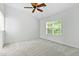An airy bedroom features a ceiling fan and bright natural light from a window at 13338 Ashford Park Dr, Raleigh, NC 27613