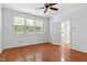 Bedroom with hardwood floors, ceiling fan and view to the bathroom at 13338 Ashford Park Dr, Raleigh, NC 27613