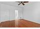 Bedroom with hardwood floors and white walls, and view to the bathroom at 13338 Ashford Park Dr, Raleigh, NC 27613