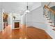 Dining area with hardwood floors, chandelier, and access to the kitchen and stairway at 13338 Ashford Park Dr, Raleigh, NC 27613