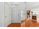 Inviting entryway with hardwood floors, a coat closet, and views into the kitchen and dining areas at 13338 Ashford Park Dr, Raleigh, NC 27613