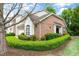 Attractive exterior featuring brick and well-maintained landscaping at 13338 Ashford Park Dr, Raleigh, NC 27613