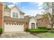 Beautifully landscaped front exterior of a brick home with trimmed hedges and a well-maintained lawn at 13338 Ashford Park Dr, Raleigh, NC 27613