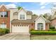 Charming two-story home with a brick and beige exterior and a well-manicured front lawn at 13338 Ashford Park Dr, Raleigh, NC 27613