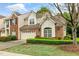 Inviting two-story home with a well-kept lawn and a combination brick and beige exterior at 13338 Ashford Park Dr, Raleigh, NC 27613