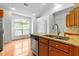 Kitchen island with stainless steel dishwasher, sink, and granite countertops at 13338 Ashford Park Dr, Raleigh, NC 27613